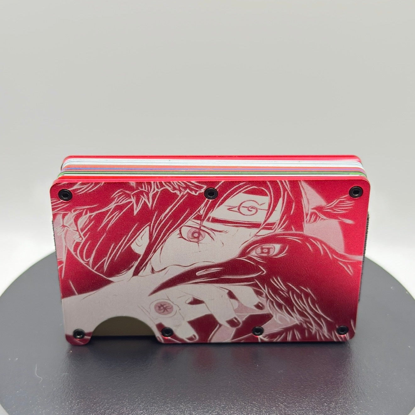 Red and white card case with anime-style illustrations on a gray background